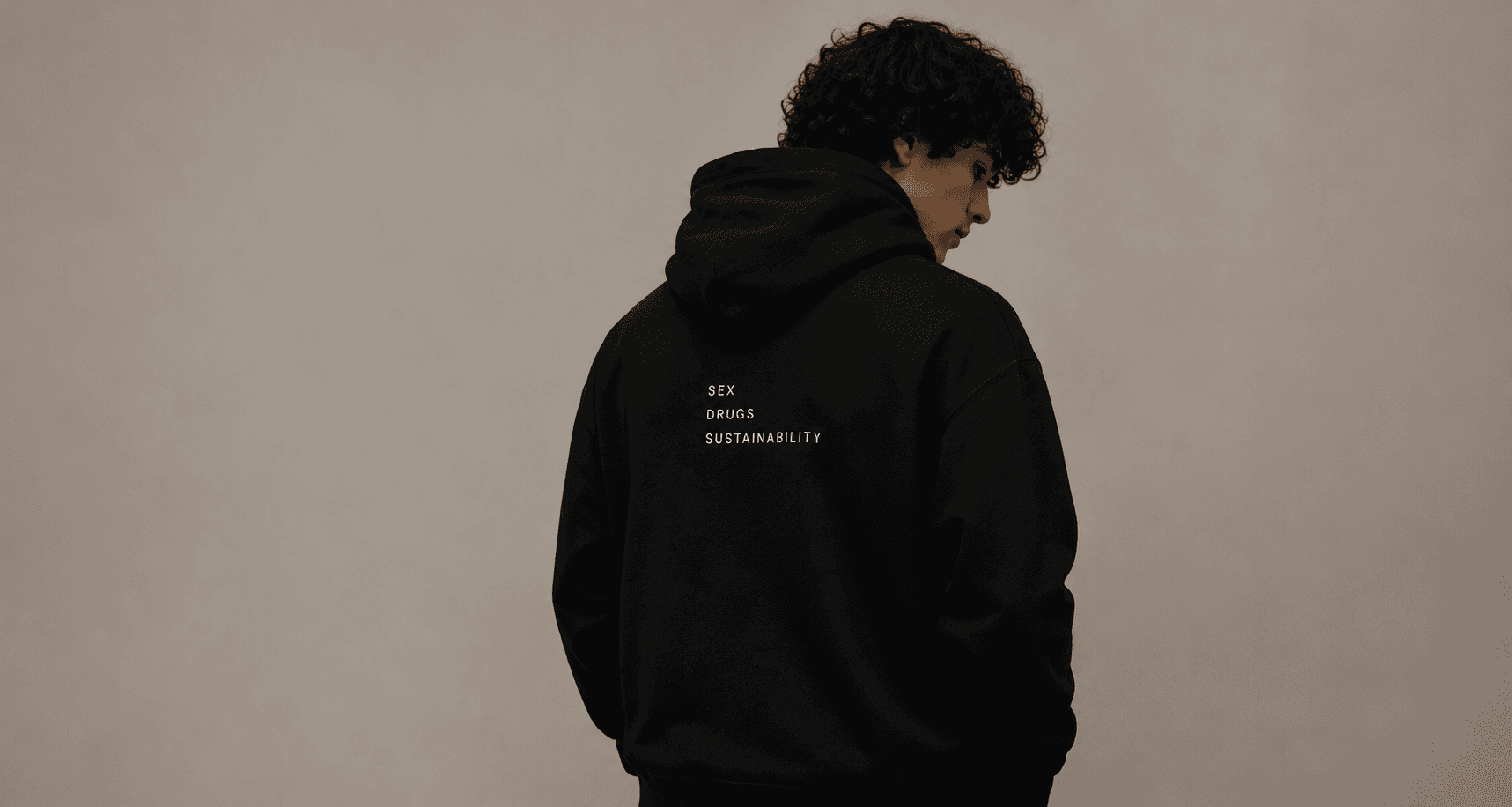 Model wearing black Sex Drugs Sustainability hoodie from behind